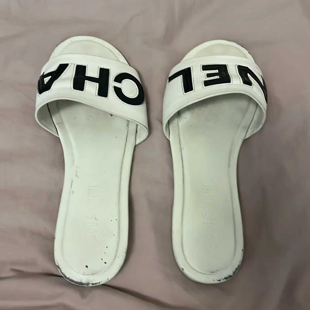 CHANEL White Slides with Black Lettering